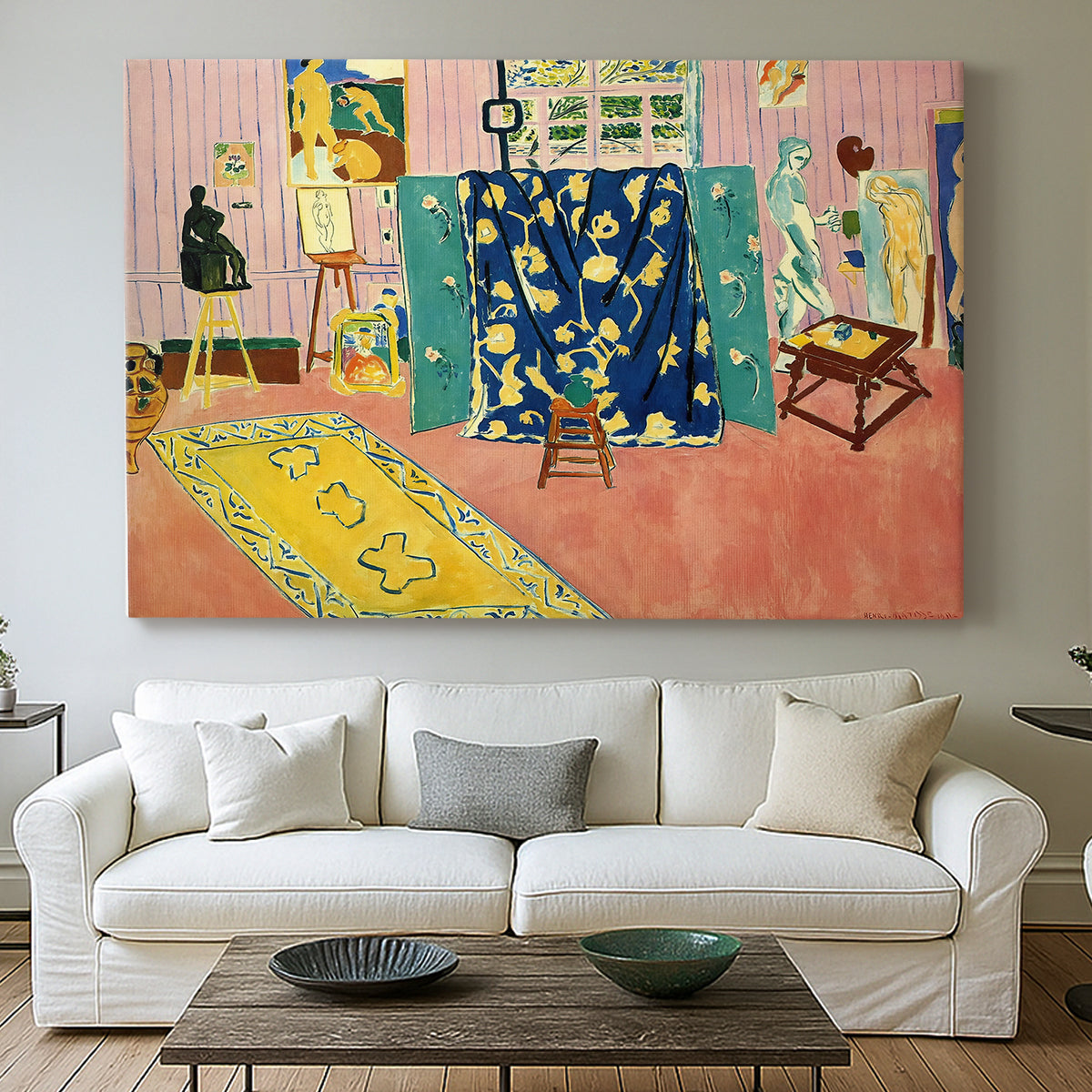 Canvas art print detailing a stylized studio composition, centered above a sofa as a large focal wall piece