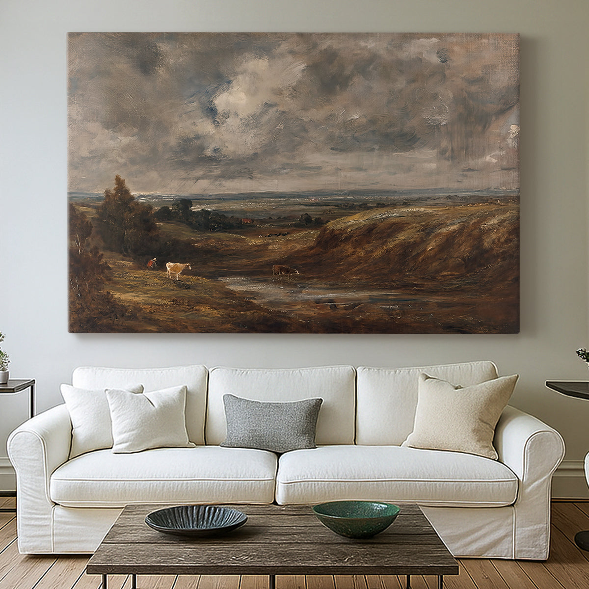 Canvas art print detailing a landscape emphasizing sky and open ground, centered above a sofa as a large focal wall piece