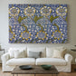Canvas art print detailing a decorative composition with layered natural motifs and symmetry, centered above a sofa as a large focal wall piece