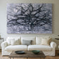 Canvas art print detailing a transitional tree pattern, centered above a sofa as a large focal wall piece