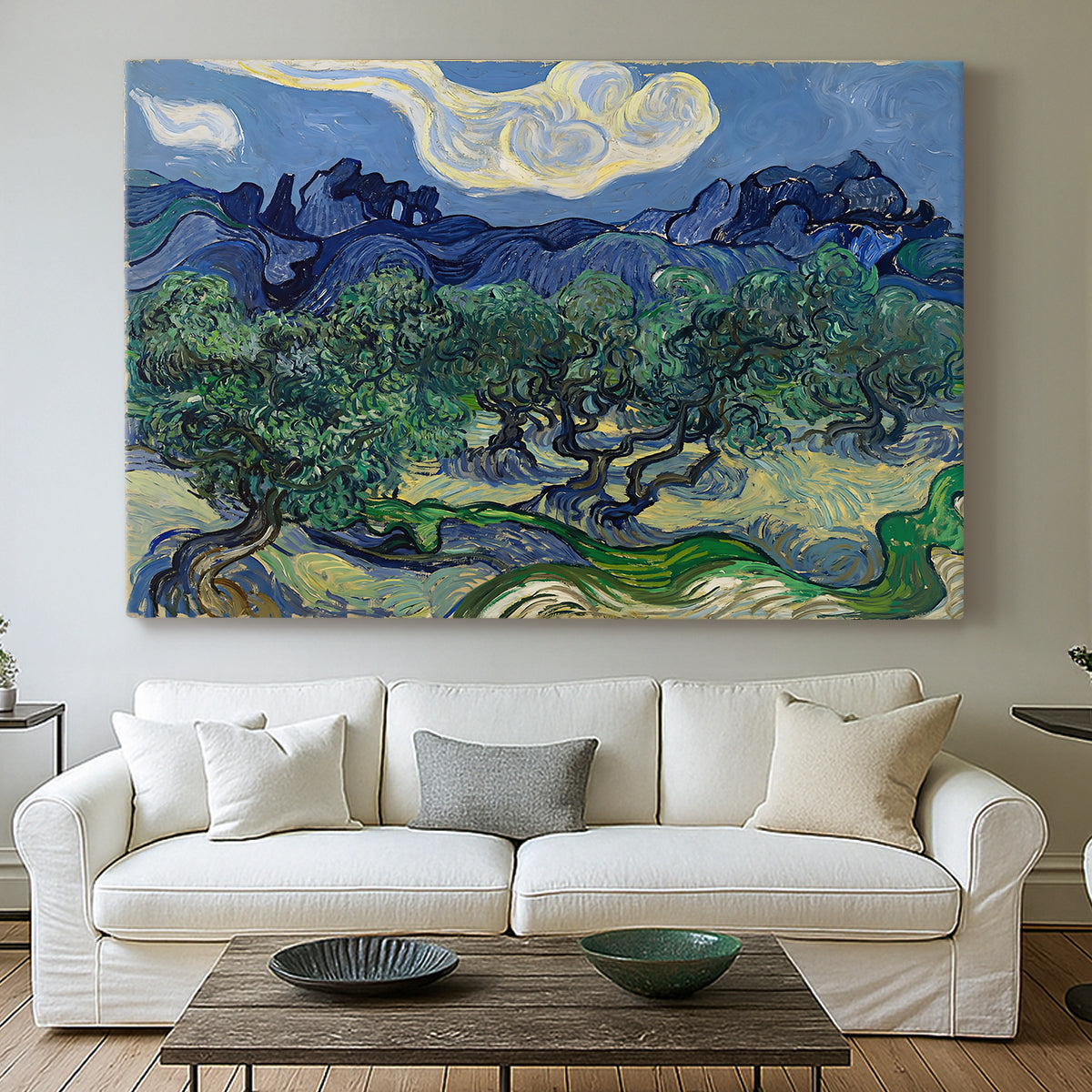 Canvas art print detailing a rural composition emphasizing contrast between trees and mountains, centered above a sofa as a large focal wall piece