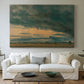 Canvas art print detailing a minimal landscape focusing on clouds, centered above a sofa as a large focal wall piece