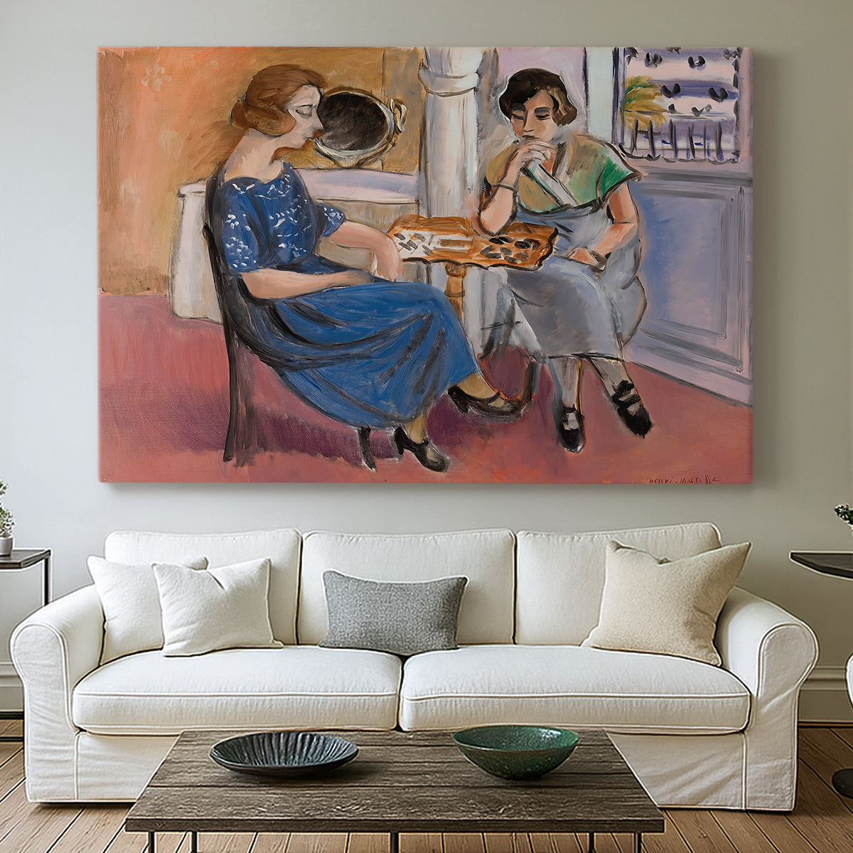 Canvas art print detailing an expressive composition of two people playing dominoes, centered above a sofa as a large focal wall piece