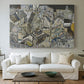 Canvas art print detailing a stylized urban composition with geometric structures and muted tones, centered above a sofa as a large focal wall piece