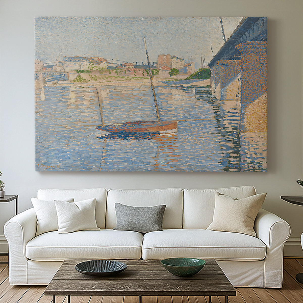 Canvas art print detailing a riverside composition with boats, centered above a sofa as a large focal wall piece