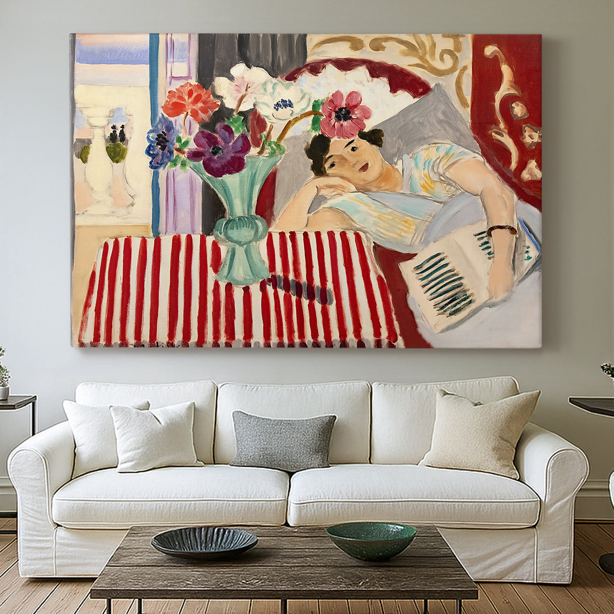 Canvas art print detailing a stylized composition with figure and decorative textiles, centered above a sofa as a large focal wall piece