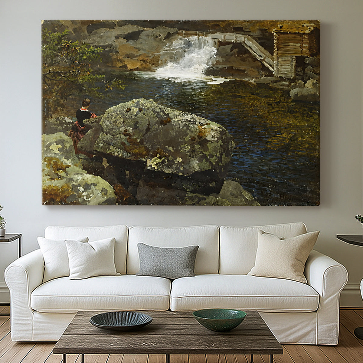 Canvas art print detailing a peaceful natural setting with mill and still water, centered above a sofa as a large focal wall piece