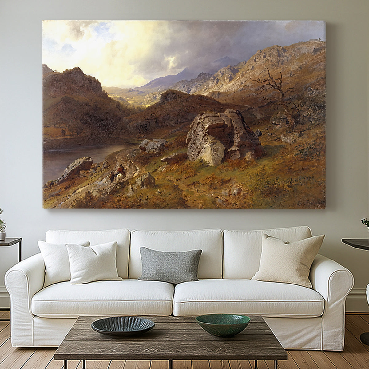 Canvas art print detailing a romantic landscape view with dramatic sky and valley, centered above a sofa as a large focal wall piece