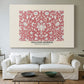 Canvas art print detailing a textile composition featuring symmetrical flower motifs, centered above a sofa as a large focal wall piece