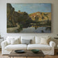Canvas art print detailing a pastoral setting with water cutting through rugged terrain, centered above a sofa as a large focal wall piece