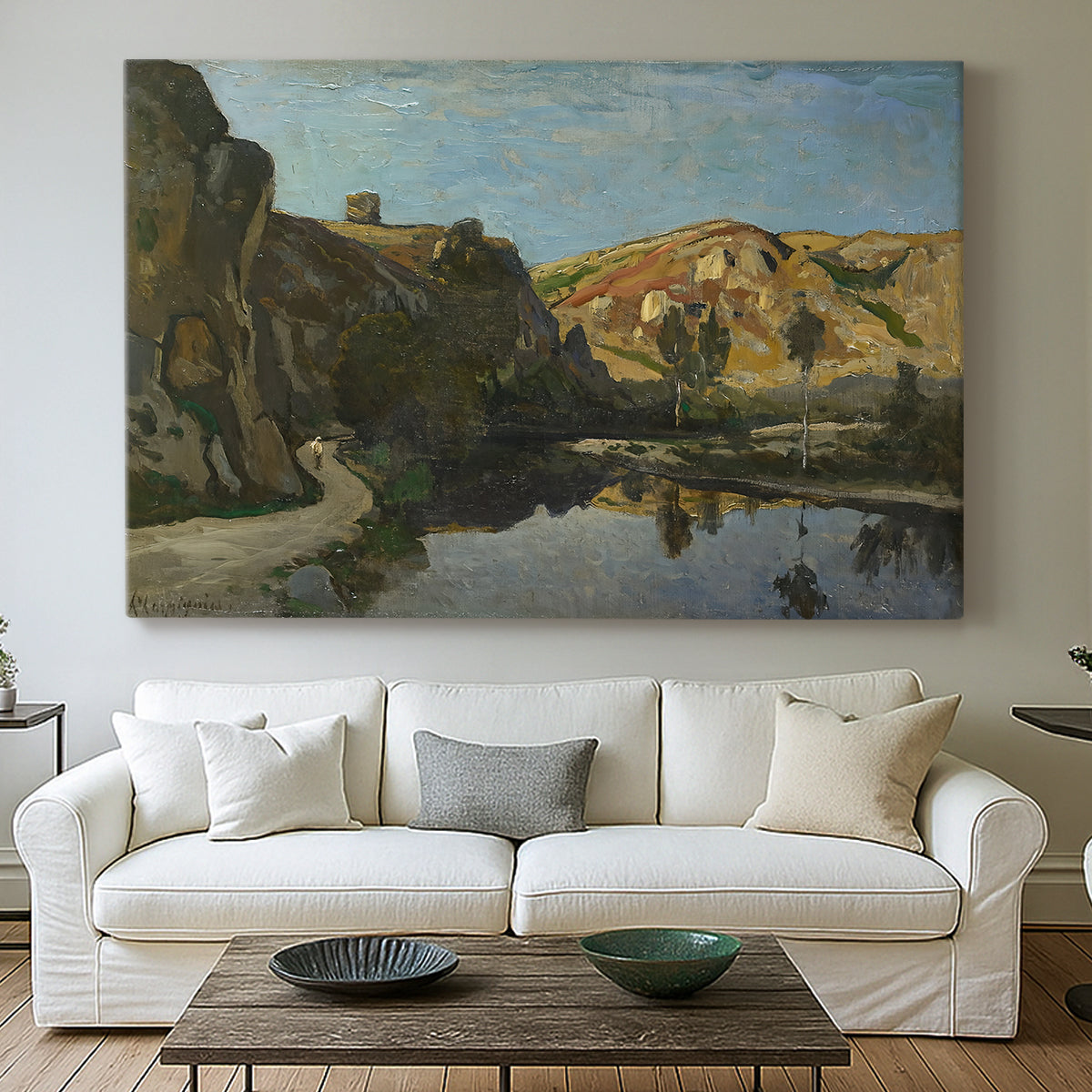 Canvas art print detailing a pastoral setting with water cutting through rugged terrain, centered above a sofa as a large focal wall piece