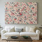 Canvas art print detailing a textile-style artwork with repeating botanical motifs, centered above a sofa as a large focal wall piece