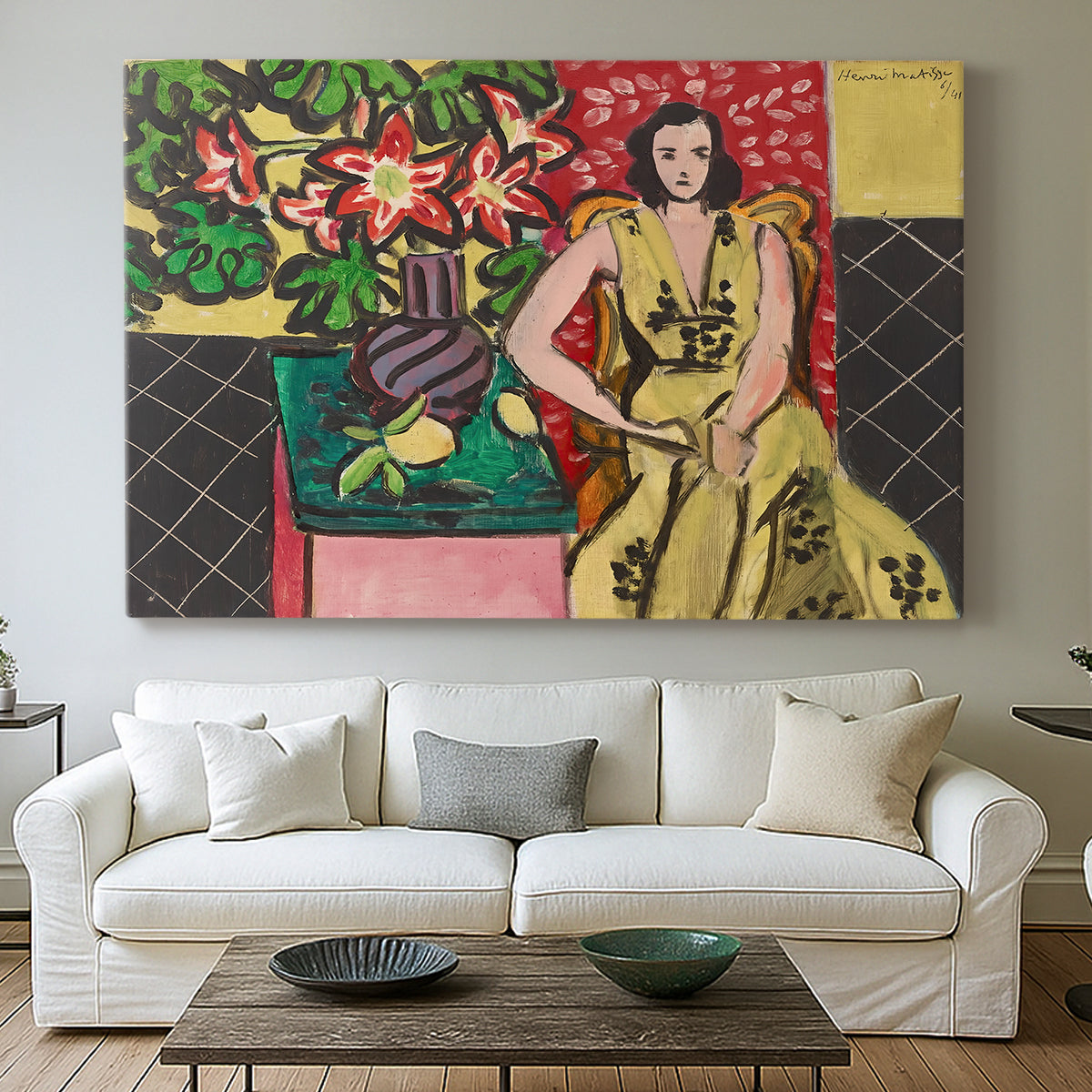 Canvas art print detailing a stylized composition of a woman next to a flower vase, centered above a sofa as a large focal wall piece