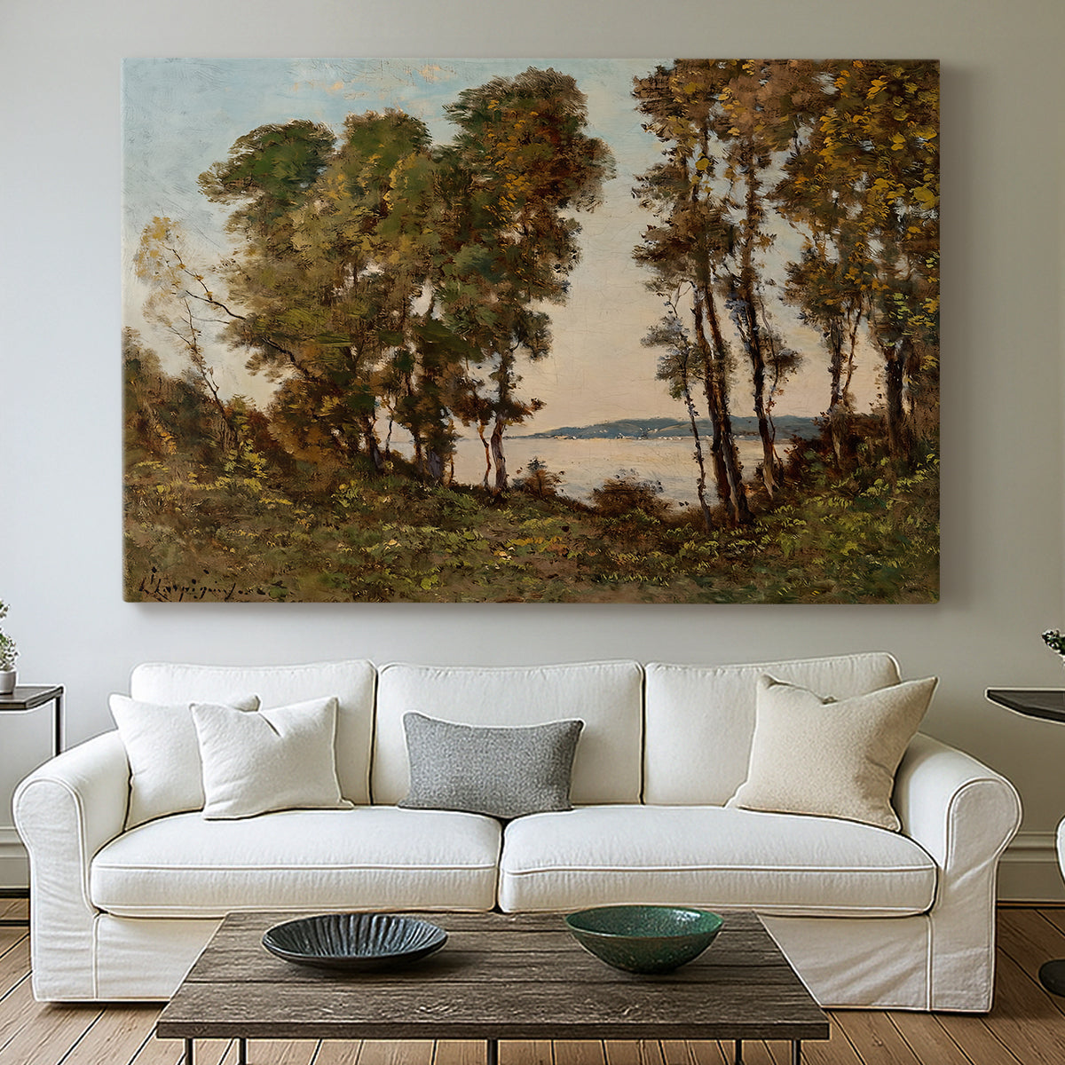Canvas art print detailing a countryside setting with river and tree-lined banks, centered above a sofa as a large focal wall piece