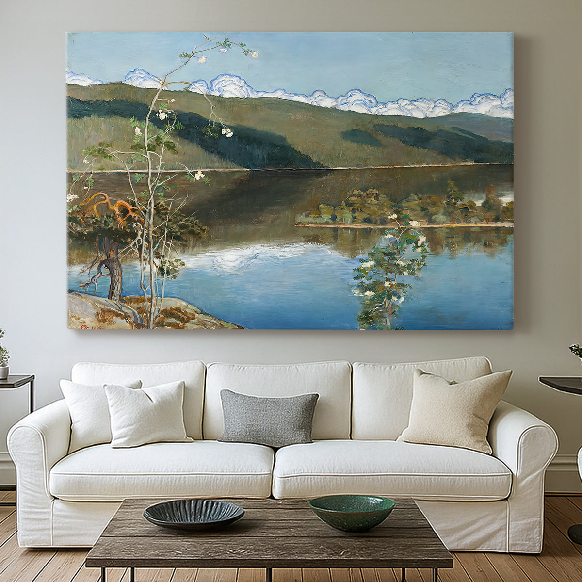 Canvas art print detailing an atmospheric landscape emphasizing turbulent sky over calm terrain, centered above a sofa as a large focal wall piece