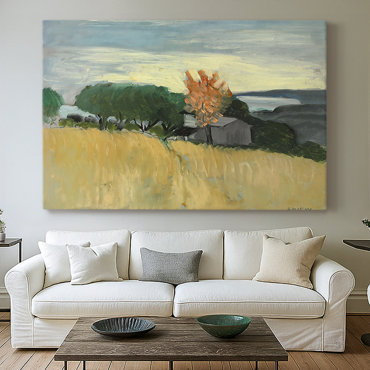 Canvas art print detailing a landscape of ripened wheat in an open natural setting, centered above a sofa as a large focal wall piece