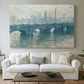 Canvas art print detailing an atmospheric urban landscape with misty light and reflections, centered above a sofa as a large focal wall piece