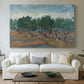 Canvas art print detailing a countryside composition with trees and dynamic color, centered above a sofa as a large focal wall piece