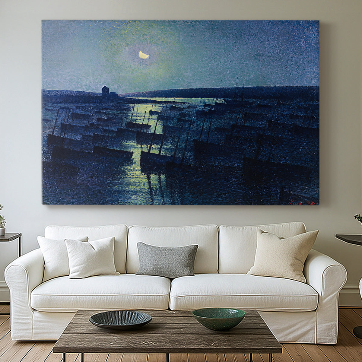 Canvas art print detailing an atmospheric harbor illuminated by moonlight, centered above a sofa as a large focal wall piece