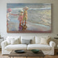 Canvas art print detailing a beach composition with figures and light, centered above a sofa as a large focal wall piece