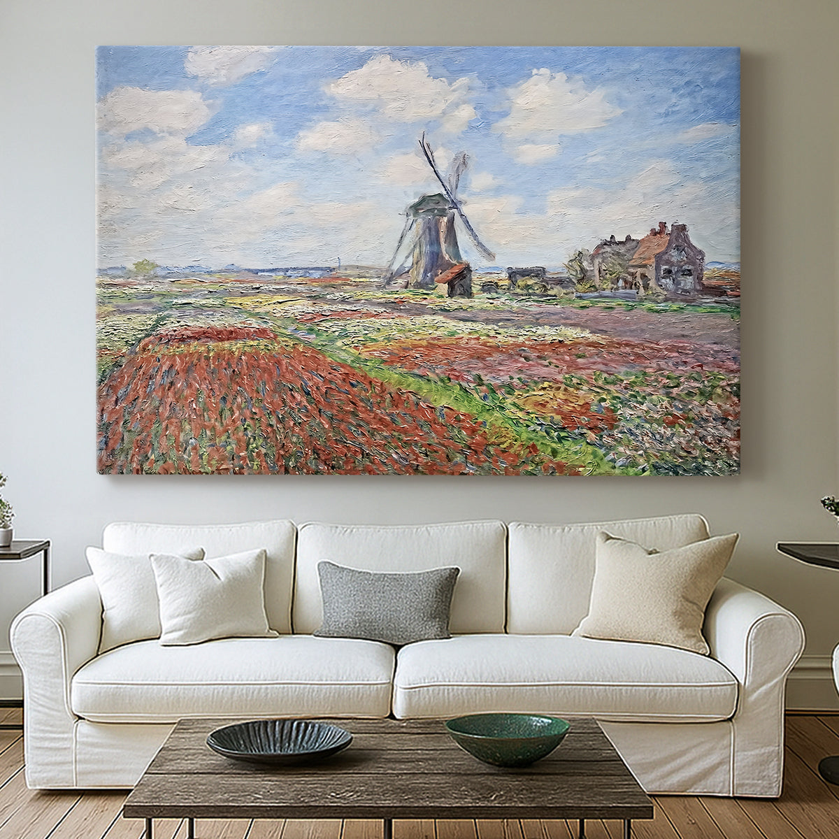 Canvas art print detailing a rural scene with patterned rows of flowers and windmill, centered above a sofa as a large focal wall piece