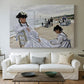 Canvas art print detailing a coastal leisure scene with figures looking out to sea, centered above a sofa as a large focal wall piece