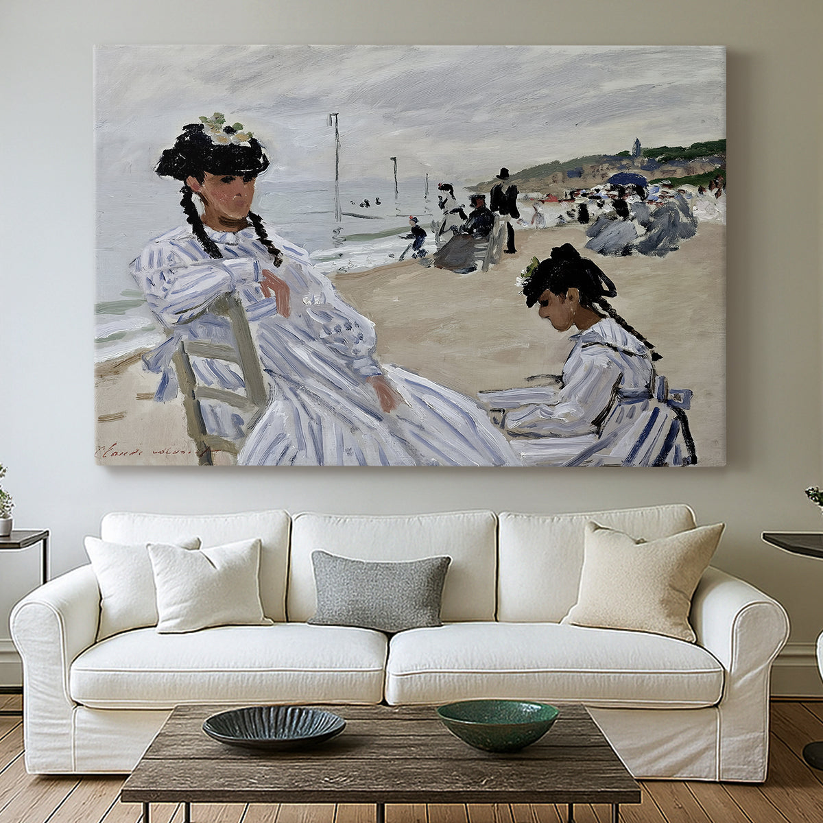 Canvas art print detailing a coastal leisure scene with figures looking out to sea, centered above a sofa as a large focal wall piece