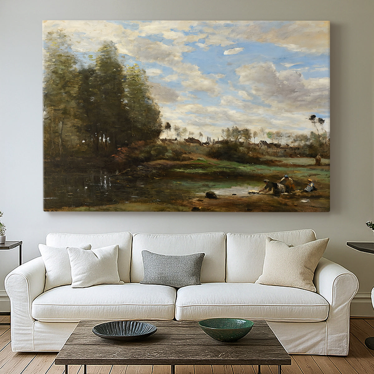 Canvas art print detailing a tranquil outdoor setting with washerwomen and river, centered above a sofa as a large focal wall piece