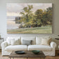 Canvas art print detailing a tranquil lakeside view with soft atmospheric tones, centered above a sofa as a large focal wall piece