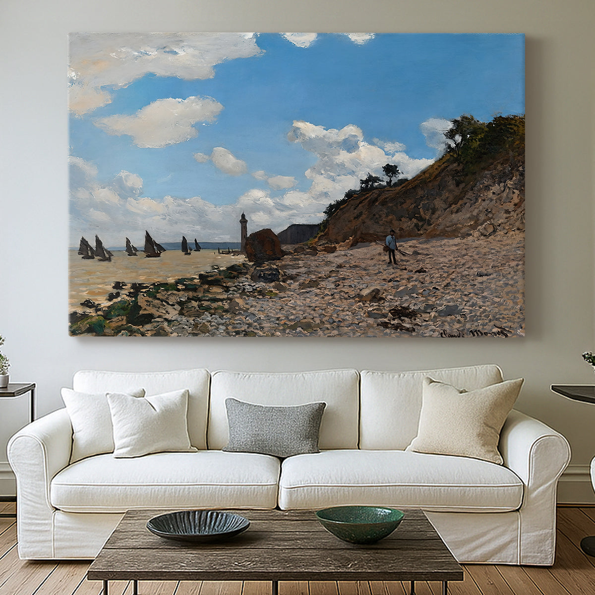 Canvas art print detailing a coastal landscape with boats and people along shore, centered above a sofa as a large focal wall piece