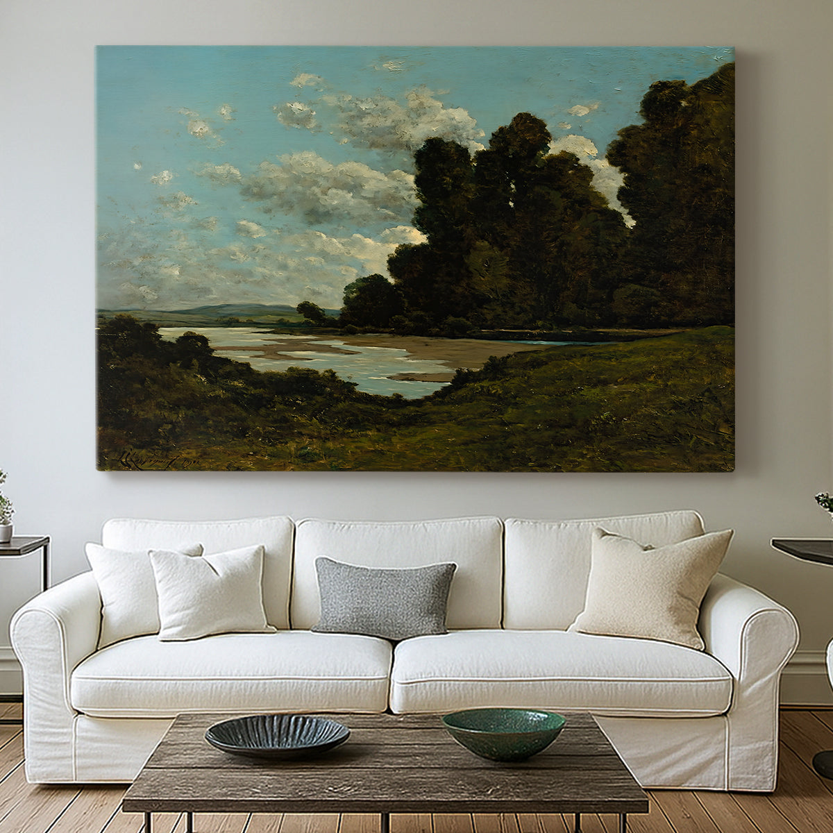 Canvas art print detailing an expansive landscape with river and built environment, centered above a sofa as a large focal wall piece