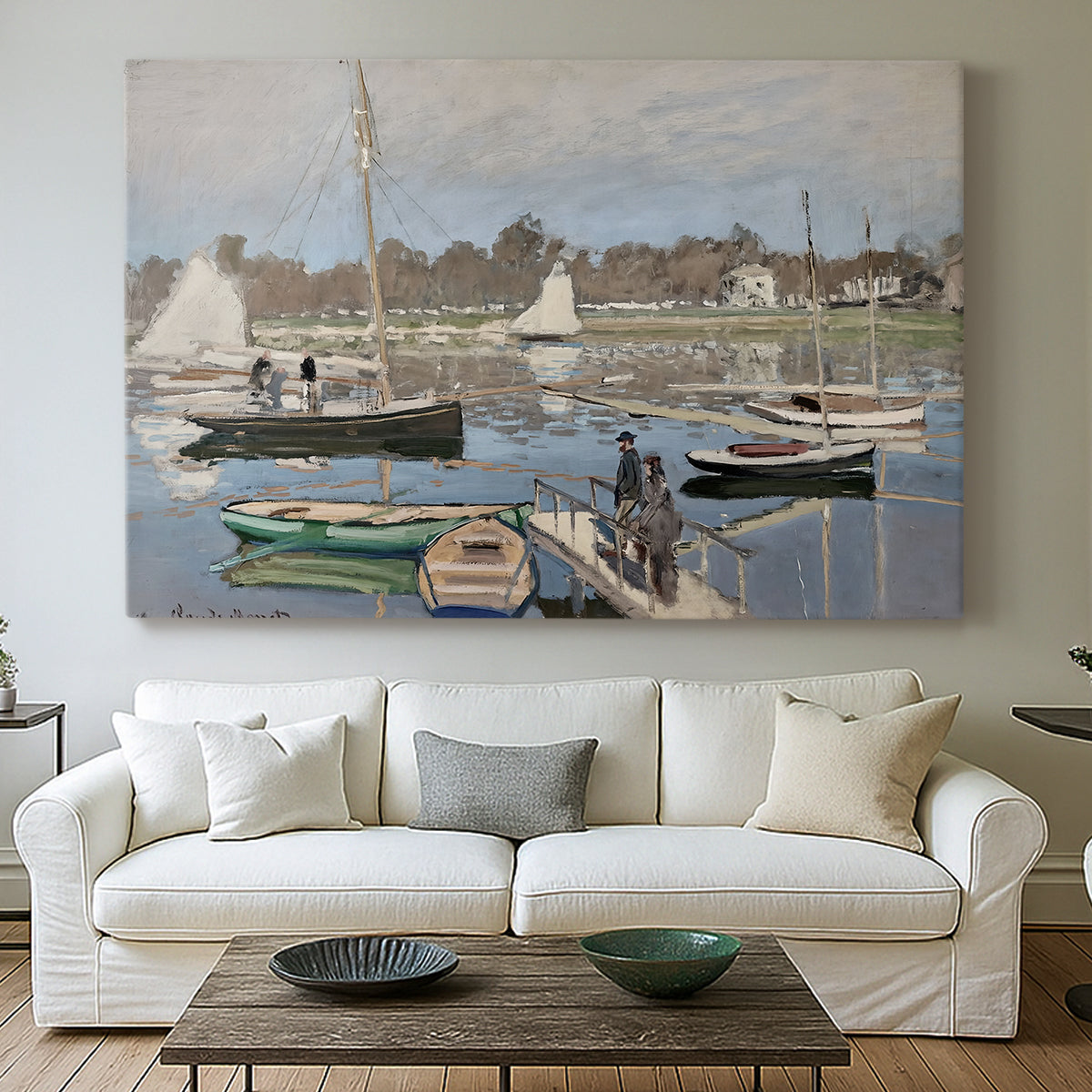 Canvas art print detailing a tranquil river setting with sailboats and shoreline, centered above a sofa as a large focal wall piece