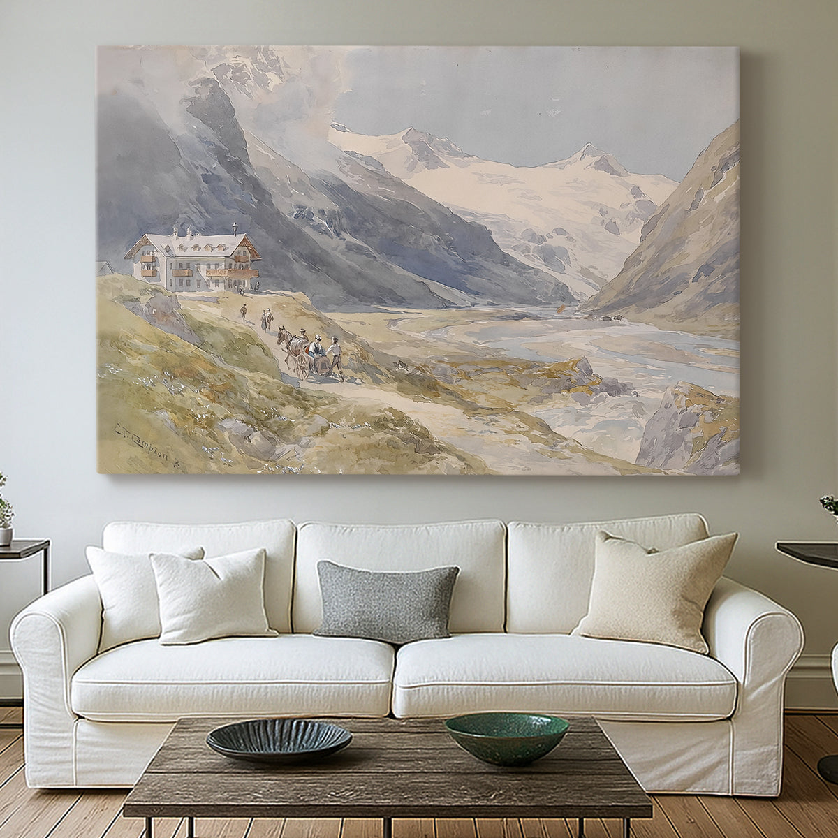 Canvas art print detailing a natural landscape with human presence among mountains, centered above a sofa as a large focal wall piece