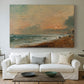 Canvas art print detailing a natural beach landscape with soft movement, centered above a sofa as a large focal wall piece