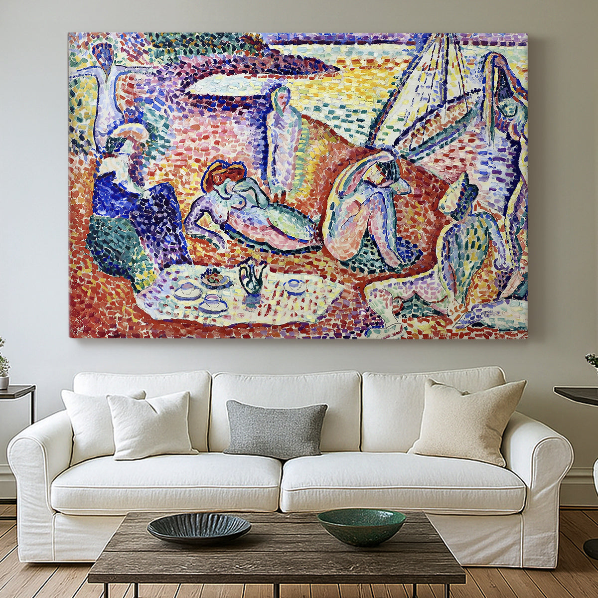 Canvas art print detailing a Fauvist coastal gathering with bright broken color, centered above a sofa as a large focal wall piece
