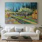Canvas art print detailing a countryside composition combining flowering trees and structure, centered above a sofa as a large focal wall piece
