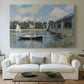 Canvas art print detailing a scenic riverscape with architecture and nautical activity, centered above a sofa as a large focal wall piece