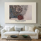 Canvas art print detailing a repeating vine motif with flowers and curved leaf forms, centered above a sofa as a large focal wall piece
