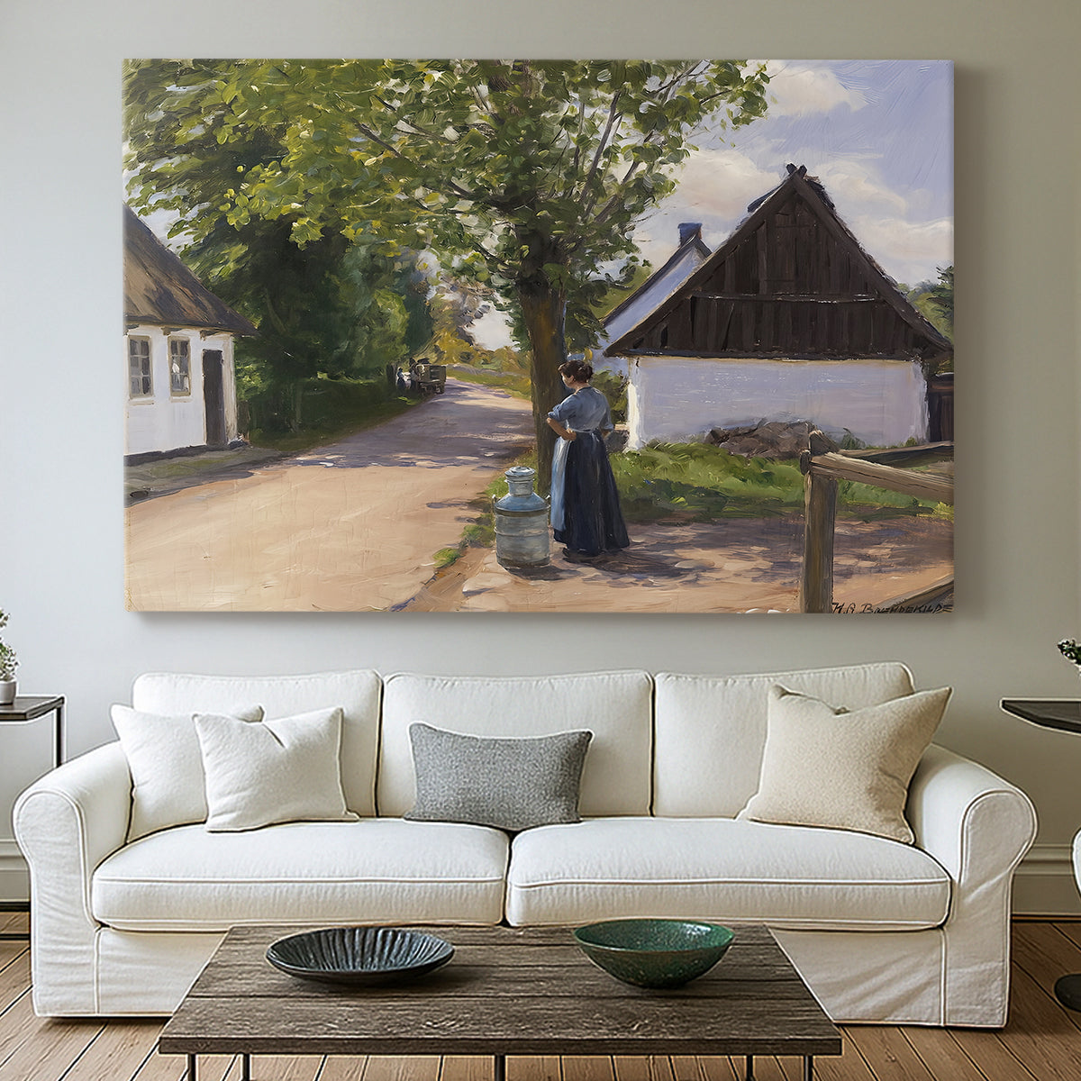 Canvas art print detailing a village setting with people and traditional architecture, centered above a sofa as a large focal wall piece