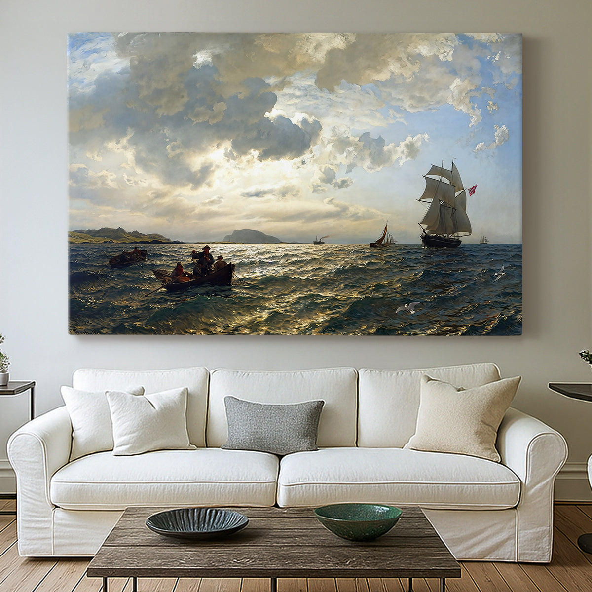 Canvas art print detailing an atmospheric coastal view with motion in sky and sea, centered above a sofa as a large focal wall piece