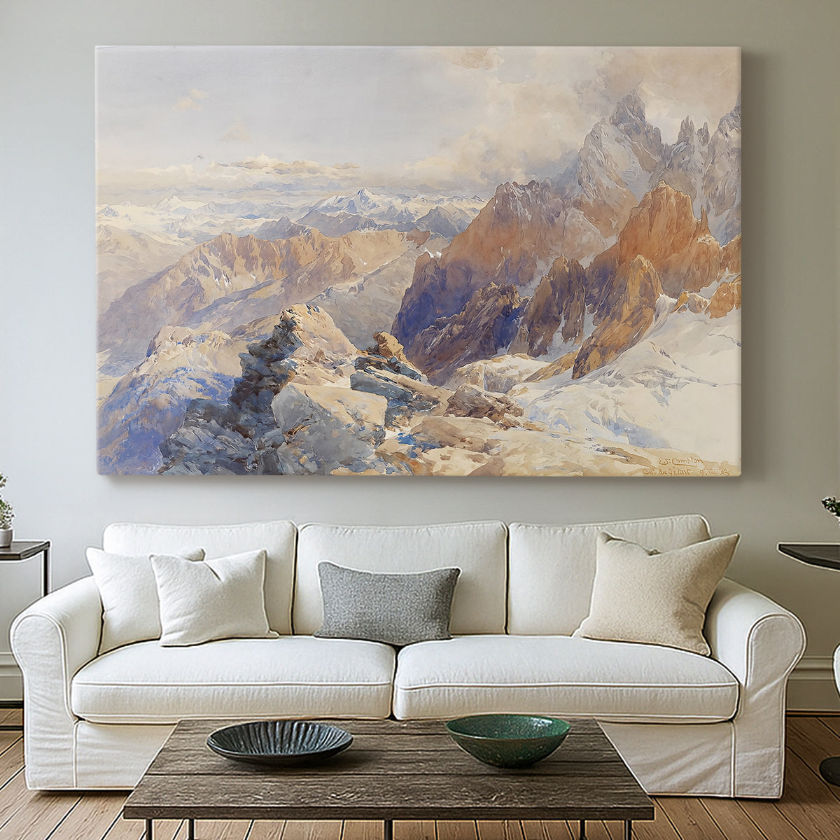 Canvas art print detailing a rugged mountain pass scene with distant peaks, centered above a sofa as a large focal wall piece