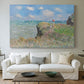 Canvas art print detailing an elevated shoreline path with figures and bright sky, centered above a sofa as a large focal wall piece