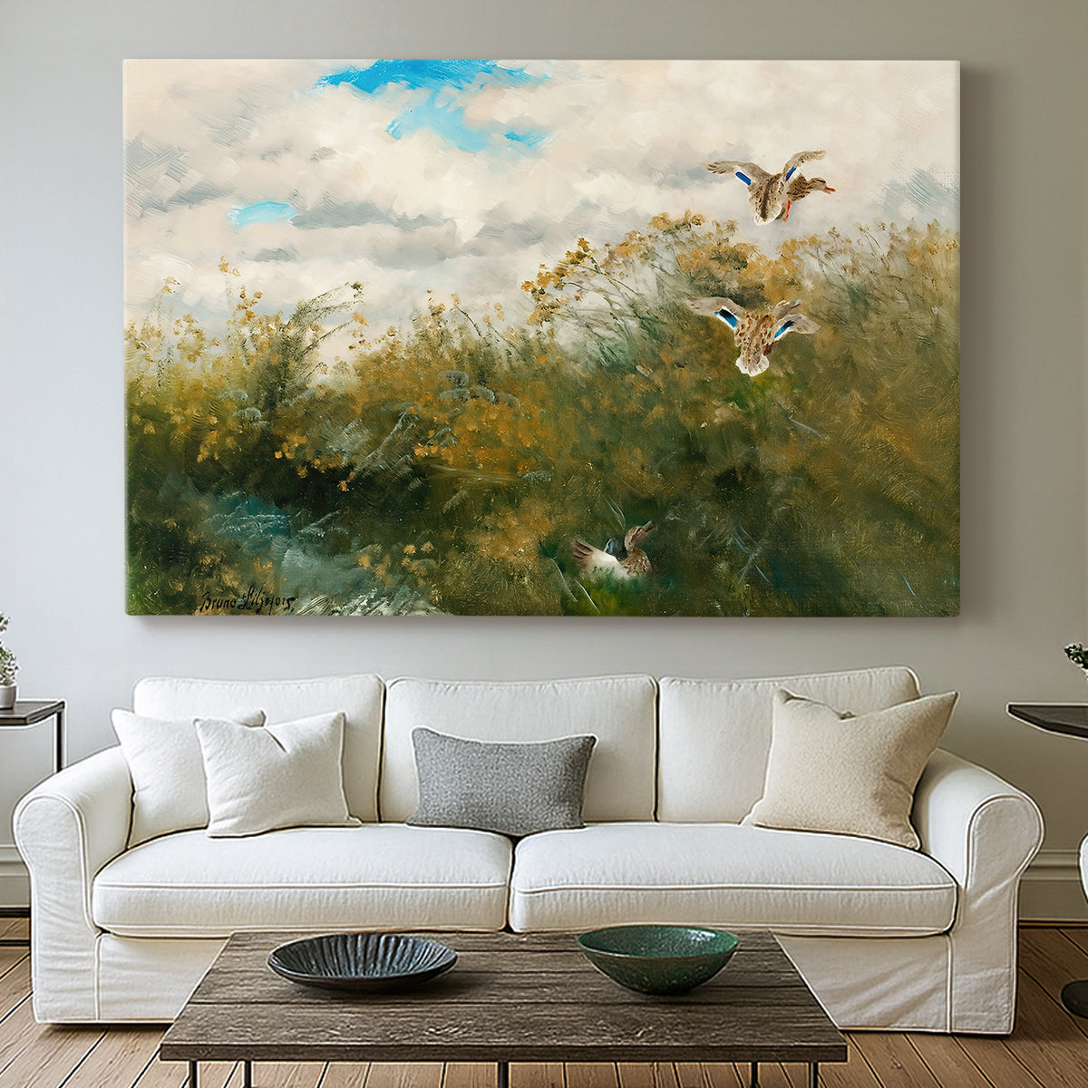Canvas art print detailing a realistic depiction of ducks in countryside landscape, centered above a sofa as a large focal wall piece