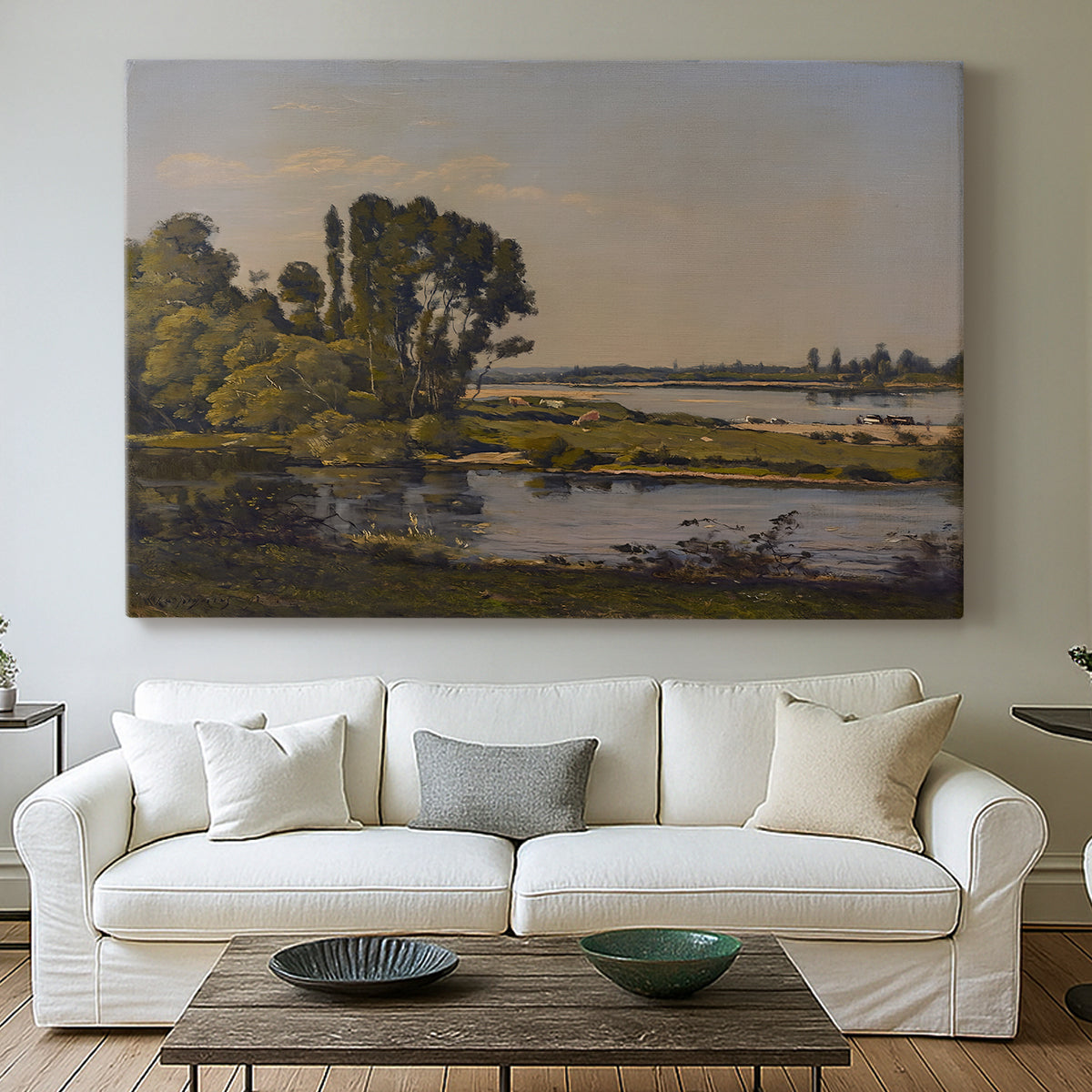 Canvas art print detailing a countryside scene with flowing water and greenery, centered above a sofa as a large focal wall piece