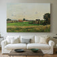 Canvas art print detailing a peaceful landscape with structure and open terrain, centered above a sofa as a large focal wall piece