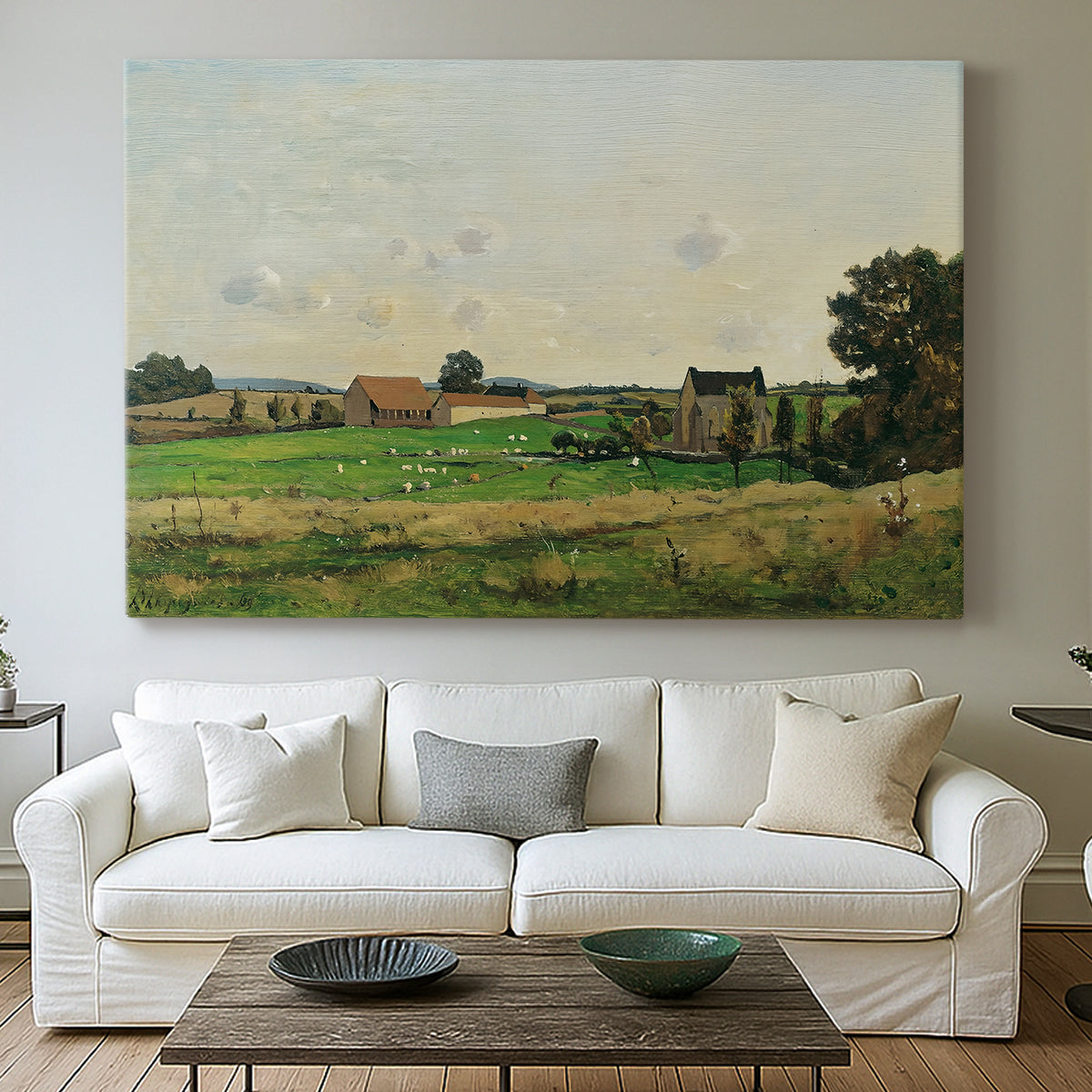 Canvas art print detailing a peaceful landscape with structure and open terrain, centered above a sofa as a large focal wall piece