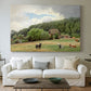 Canvas art print detailing a countryside setting with animals and farmhouse under soft sky, centered above a sofa as a large focal wall piece