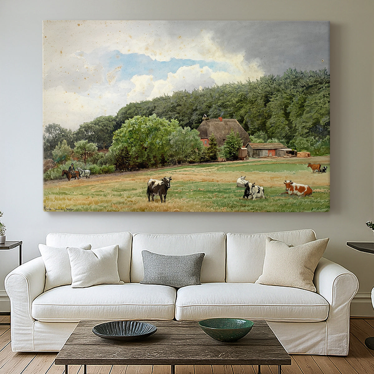 Canvas art print detailing a countryside setting with animals and farmhouse under soft sky, centered above a sofa as a large focal wall piece