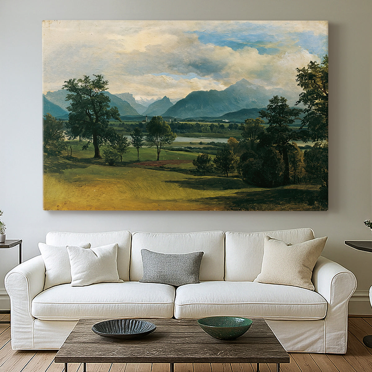 Canvas art print detailing a countryside view with soft atmospheric perspective, centered above a sofa as a large focal wall piece