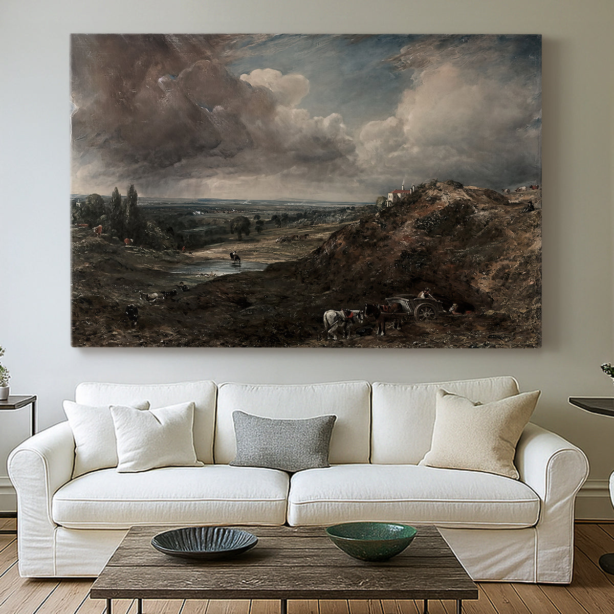Canvas art print detailing a countryside view emphasizing water and sky, centered above a sofa as a large focal wall piece